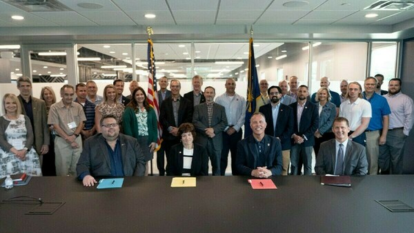 Representatives from Notre Dame, including Vice President for Research Jeff Rhoads; Indiana University, Purdue University and NSWC Crane pose for photo at MOU signing